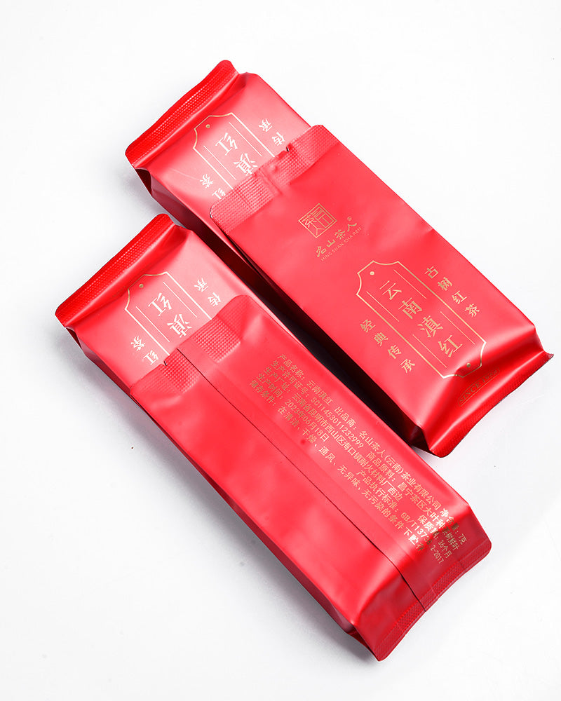Two Classic Yunnan Red tea bags by Zen Tea Master on a white surface.