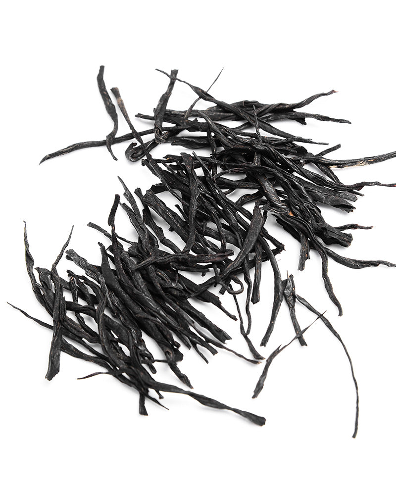 A pile of Zen Tea Master Chinese Black Tea 130g leaves on a white background.