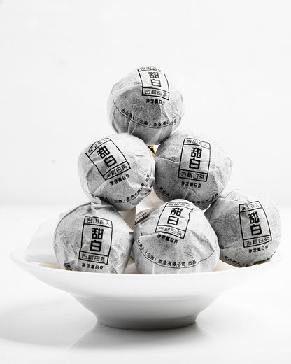 Five Sweet White Antique Tree Beads 8g/80g stacked on top of each other, offering a fresh and flavorful taste with the refinement of Yunnan wild tea from Zen Tea Master.